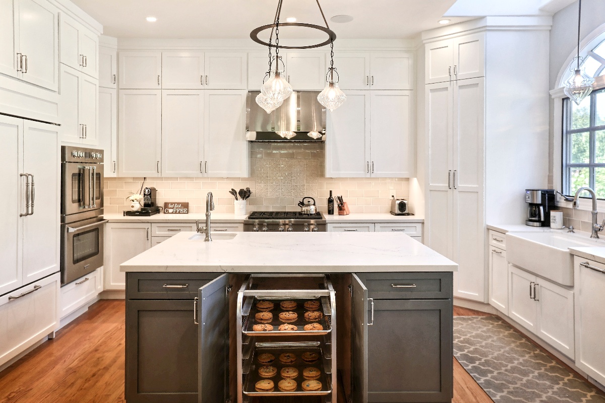 wide angle kitchen remodel with hard wood flooring and a baking rack built into the island