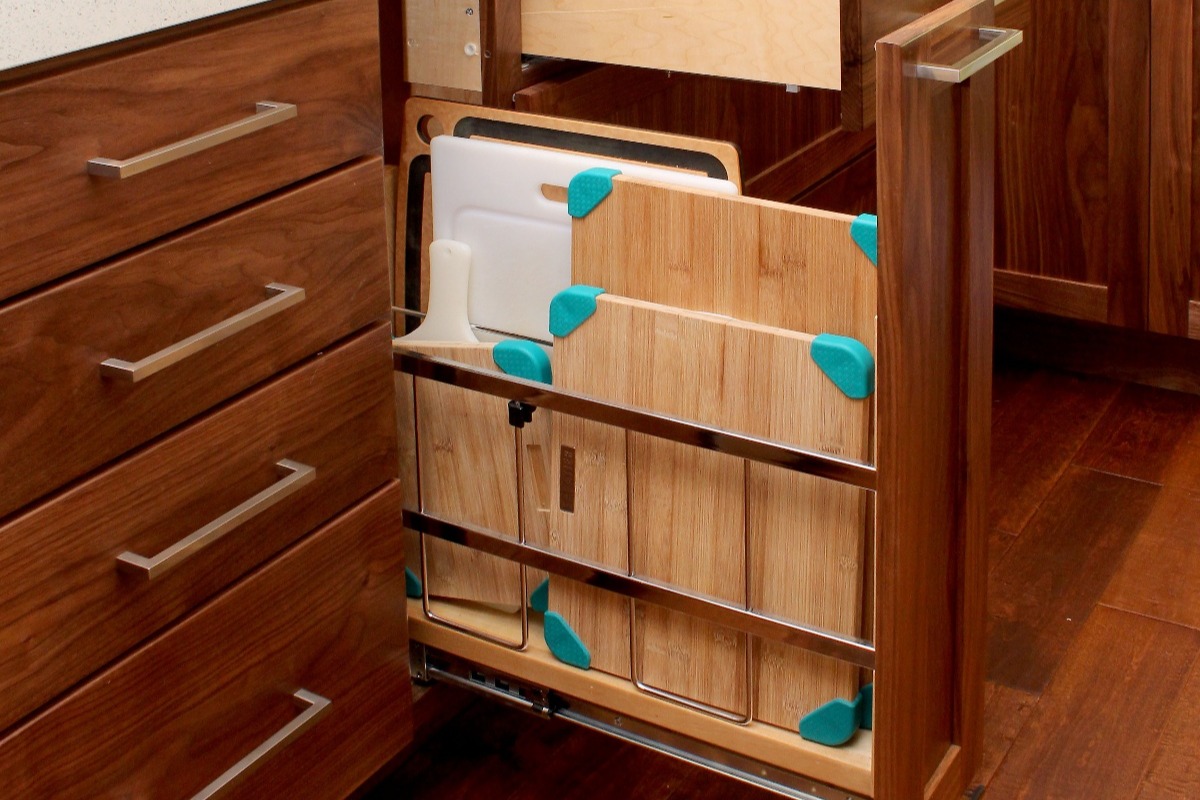 Vertical pull out cabinet for storing cutting boards and taller items
