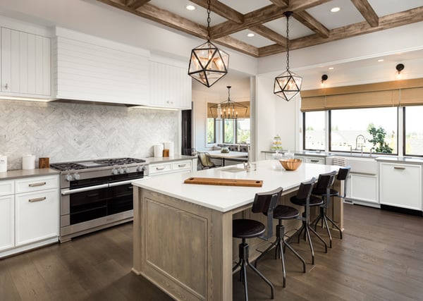 Luxury kitchen with large quartz countertops and rustic lighting fixtures