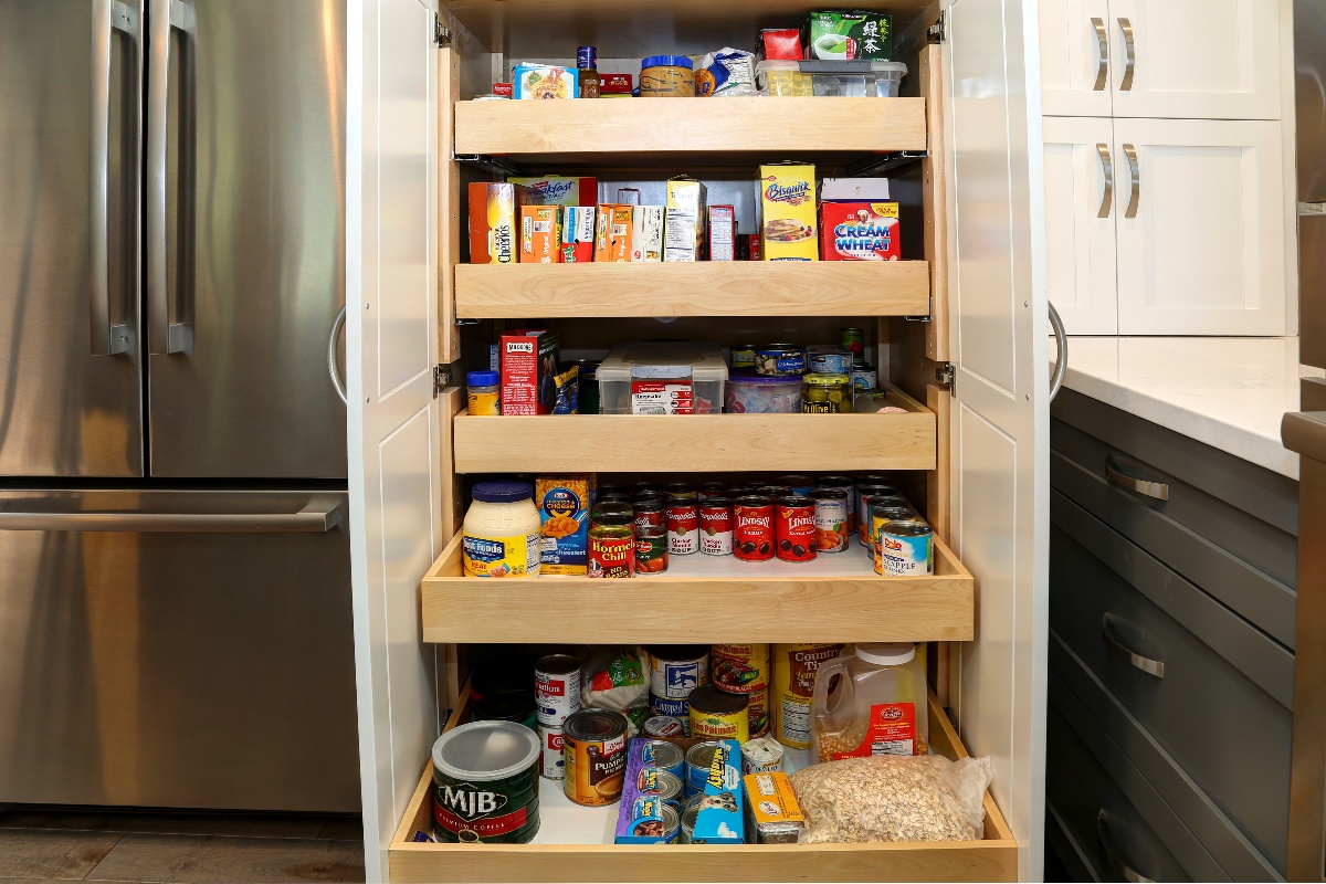 Pantry pullout shelves with spices and boxed groceries well organized