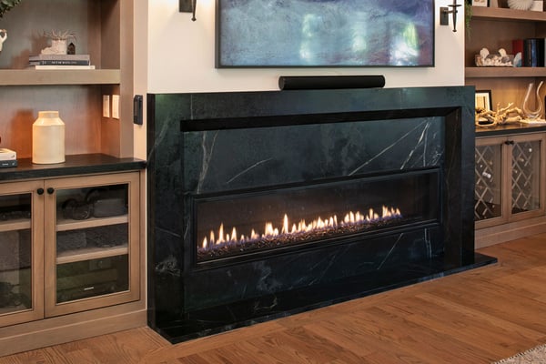 Cozy home fireplace with real flames and a black marble finish