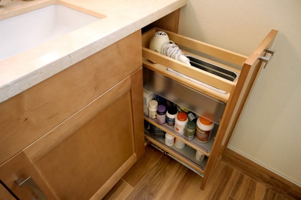 Pull out medicine storage cabinet with a hair dryer holder for the bathroom counter