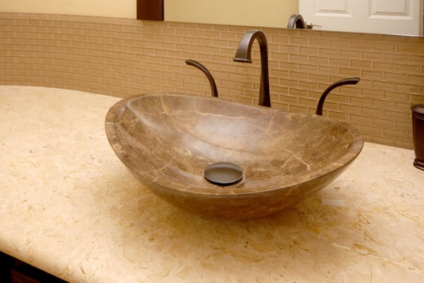 Striking bathroom sink basin with above counter bowl and brushed steel fixtures