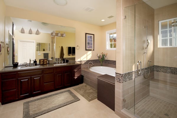 bathroom remodel in Santa Cruz county with lightly colored tile accents, and contrasting wood cabinetry