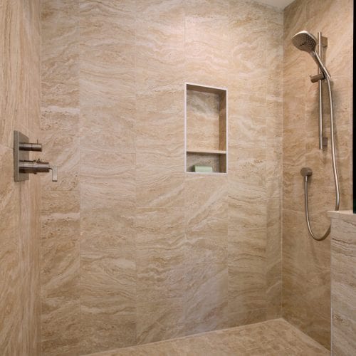 Full tile walk-in shower with detachable shower head.