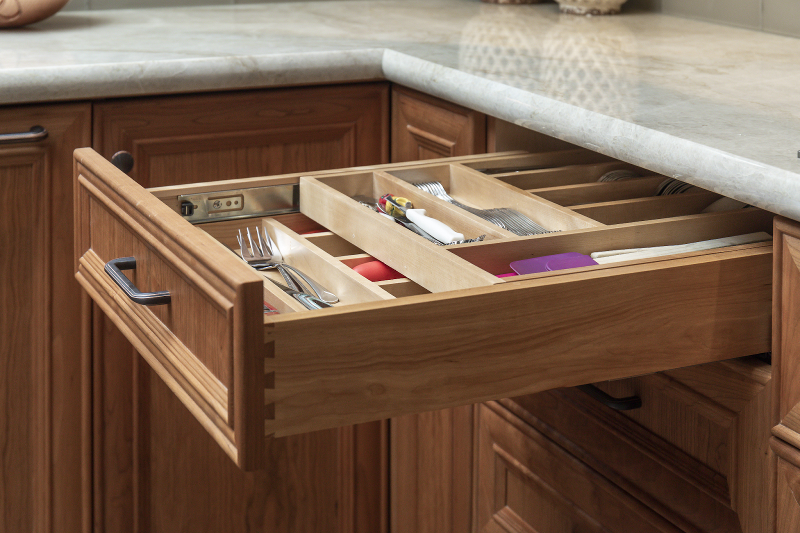 Kitchen utensil drawers with adjustable peg drawers for added storage
