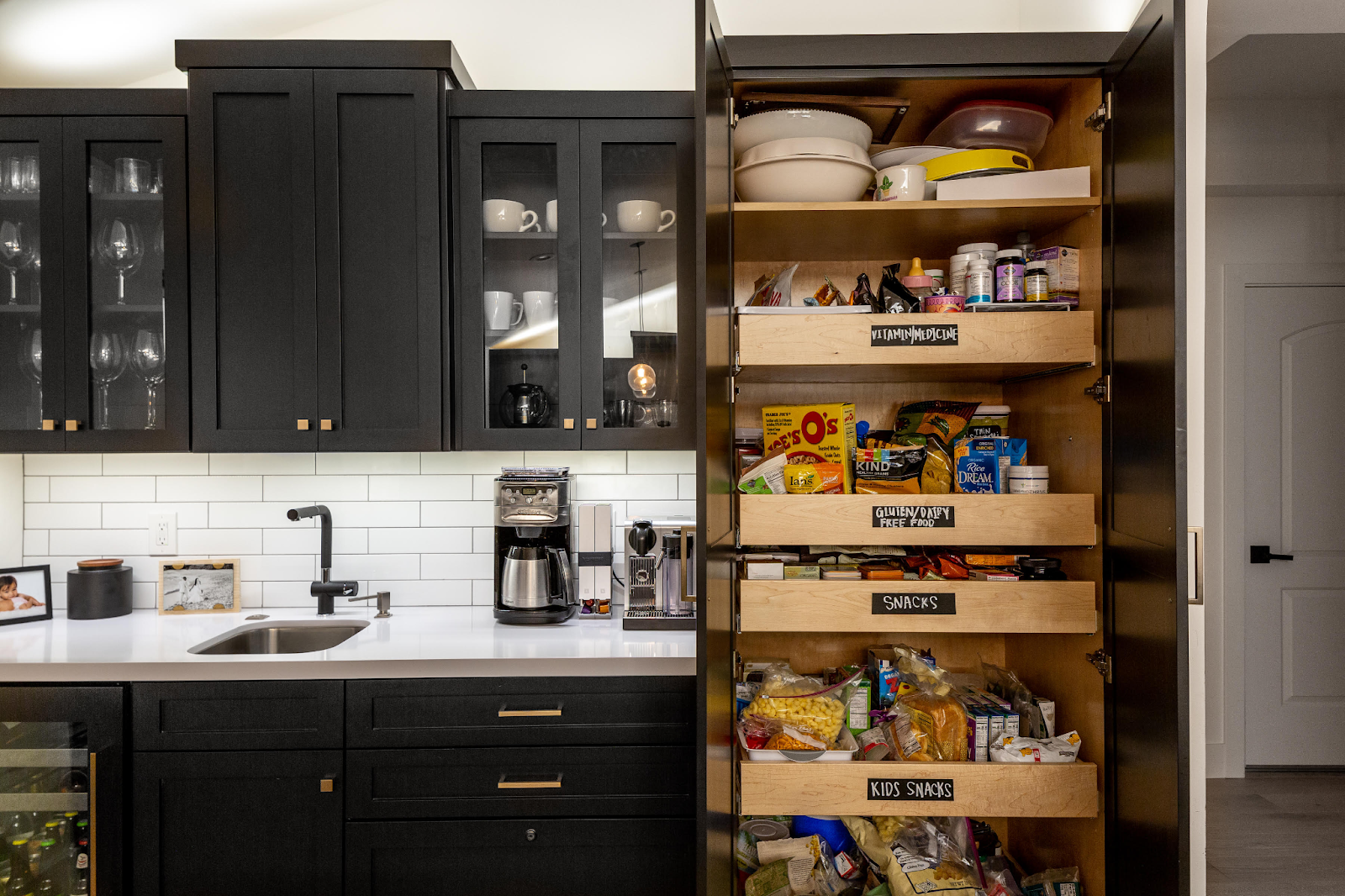 Photo of rollout cabinet storage with black labels for the contents within