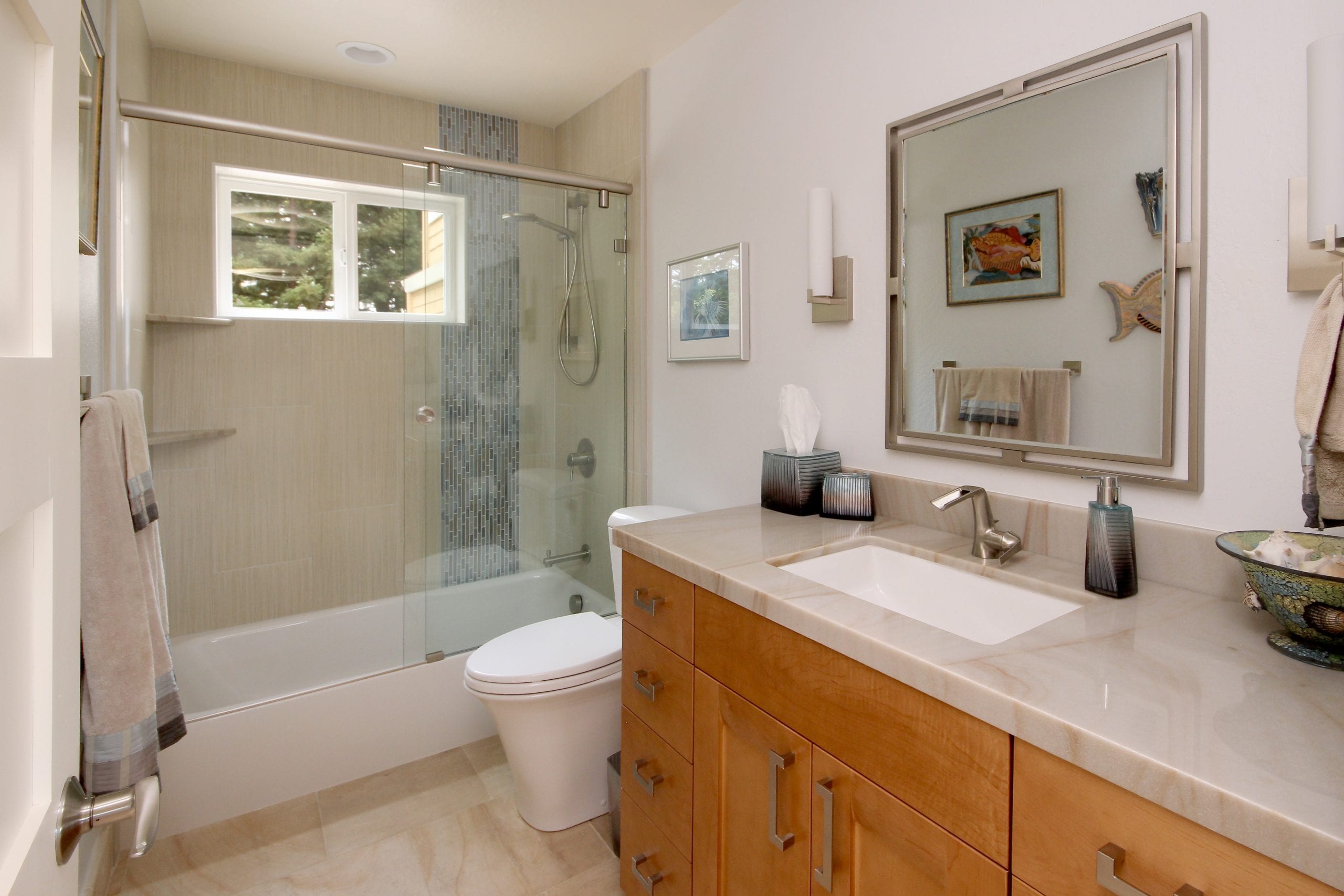 Bathroom with finished wood cabinets and glass sliding shower door