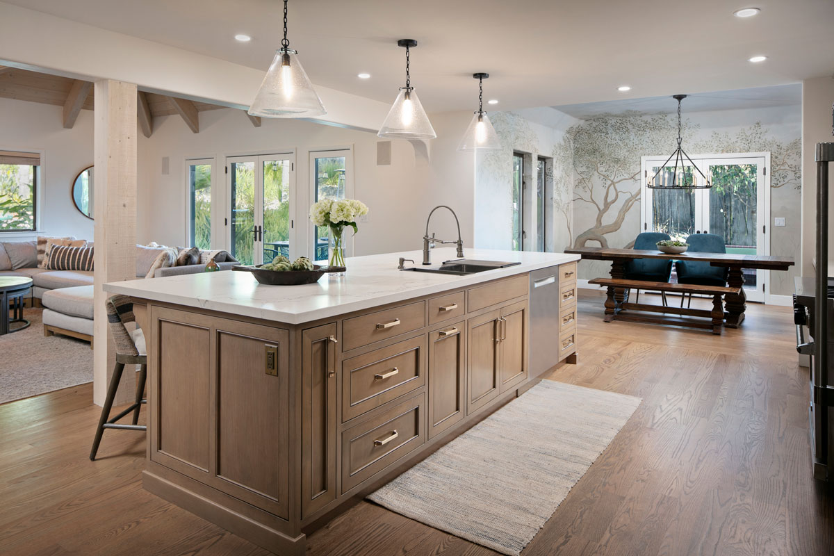 Contemporary and traditional kitchen with a pastel color palette and a kitchen island with a built in kitchen sink basin