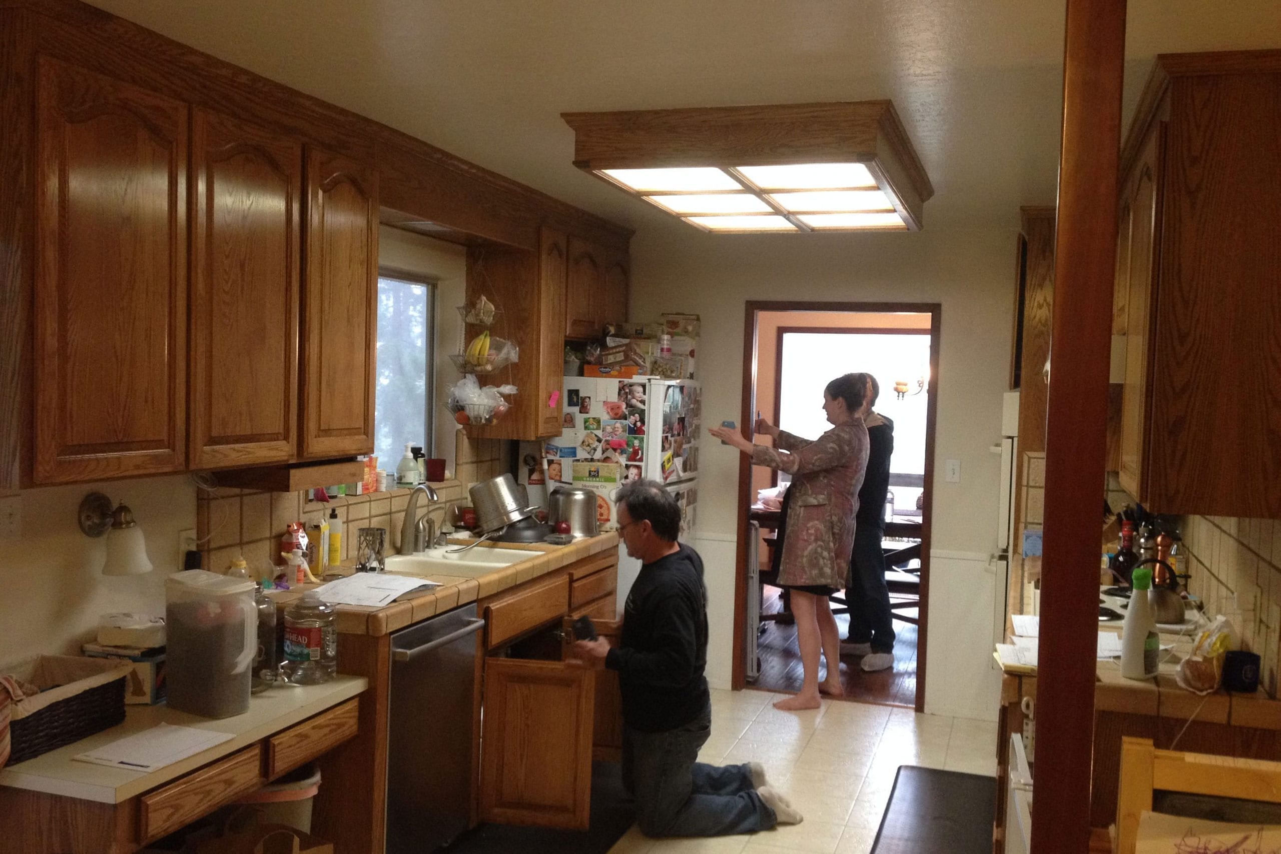 Before kitchen remodel dim lighting, a skylight and small footprint