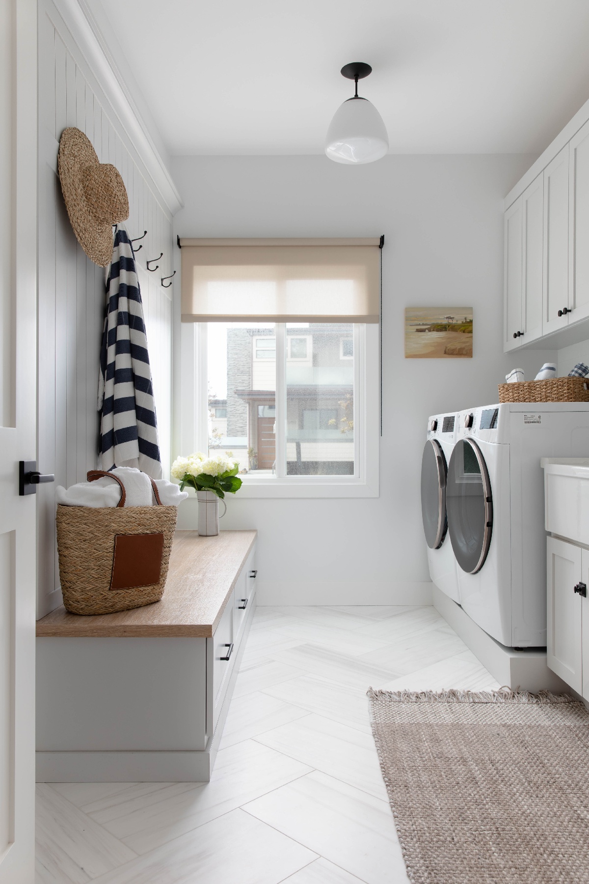 Laundry room with white color palette and side by side front loading washer and dryer