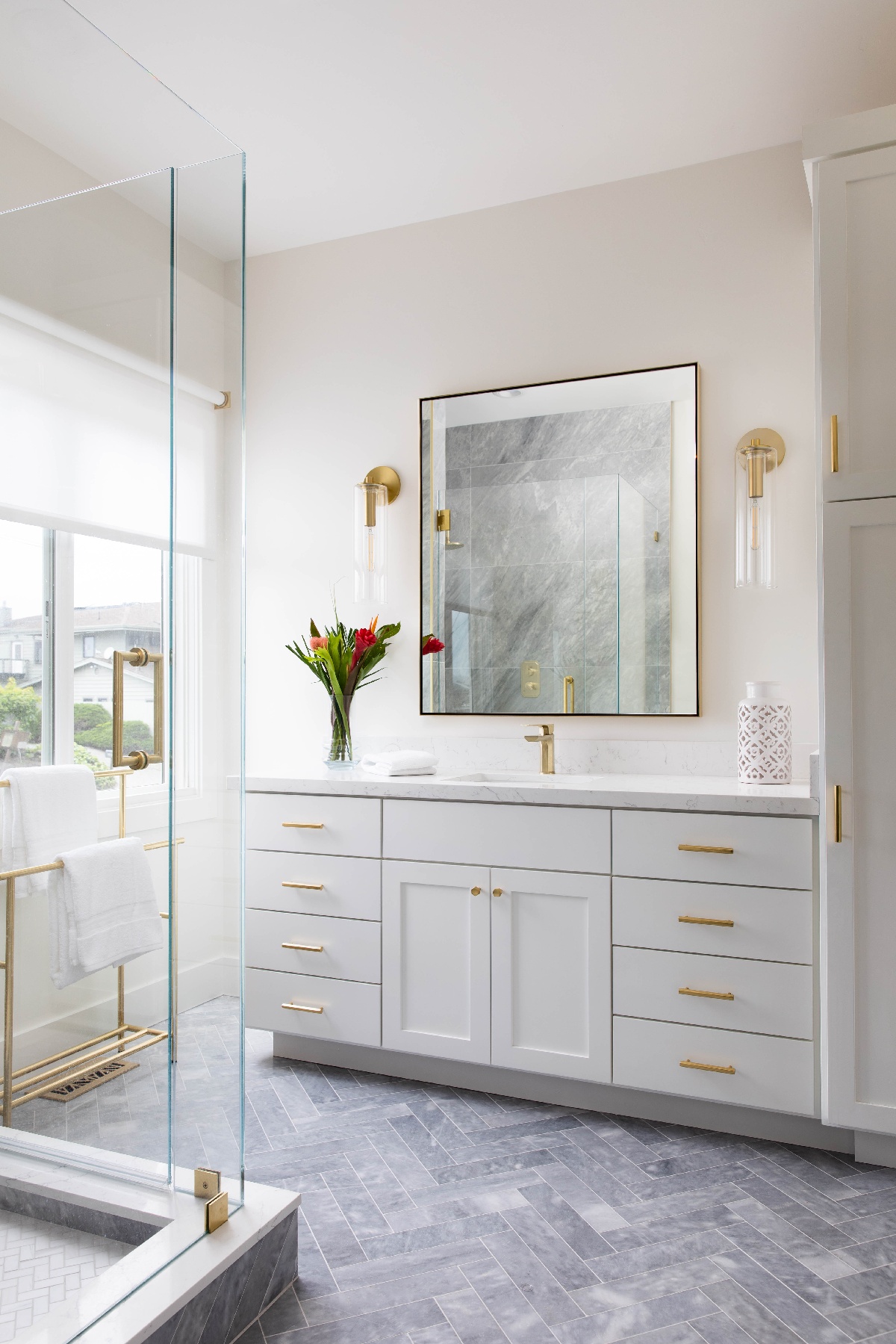 Bathroom mirror with white cabinetry and storage