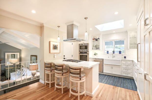 A luxurious, contemporary, and pure kitchen remodel with coastal design elements and a spacious kitchen island