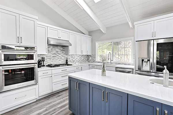Kitchen with white and blue color scheme and a stand-alone island