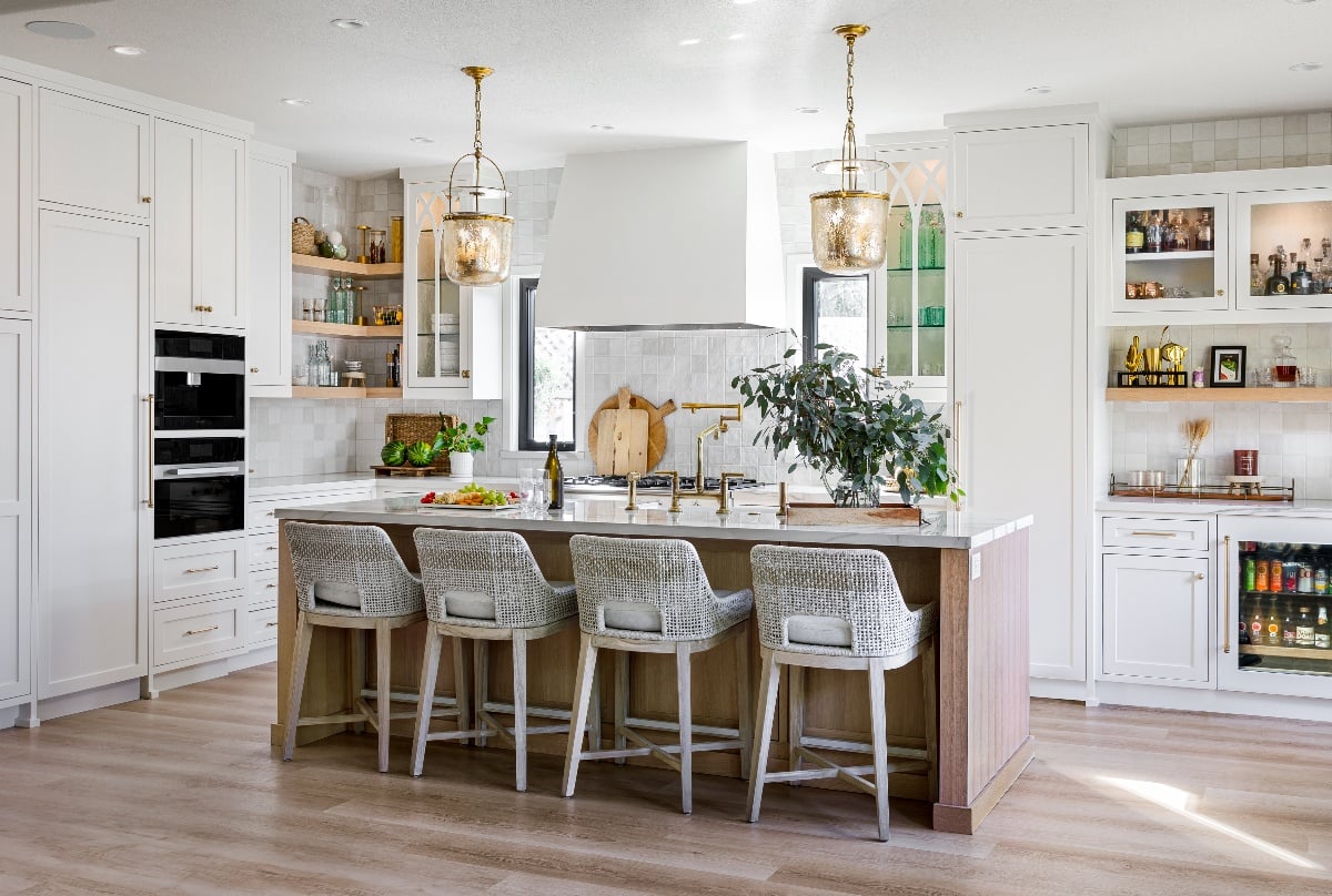 Functional kitchen with an island for dining and a butler's pantry off to the right and tons of natural light