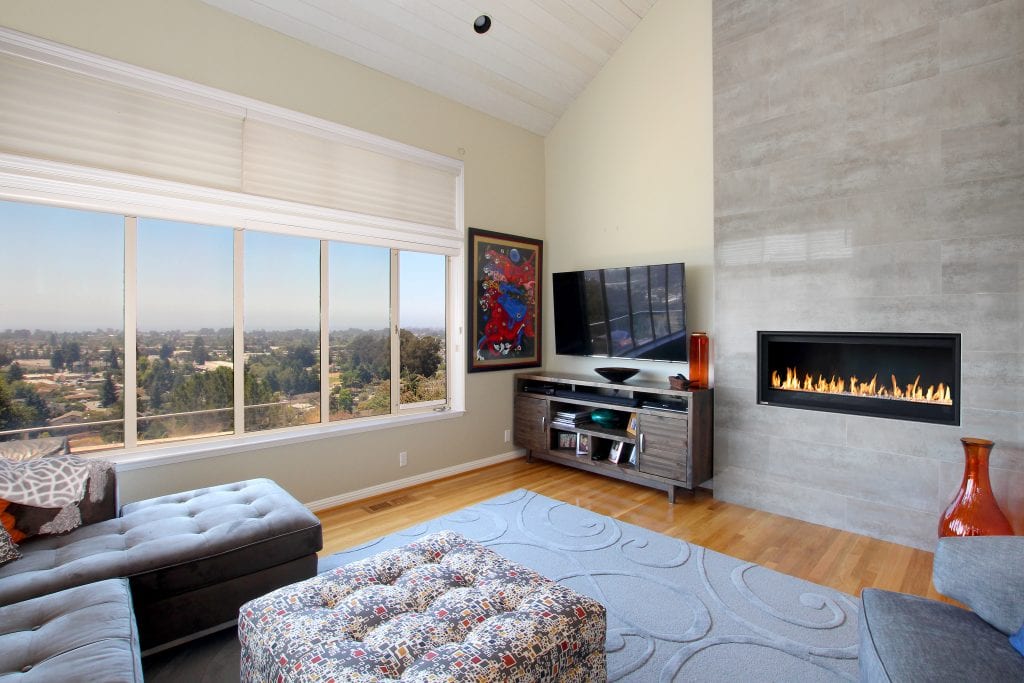 Living room with hardwood floor, built-in fire place and large window