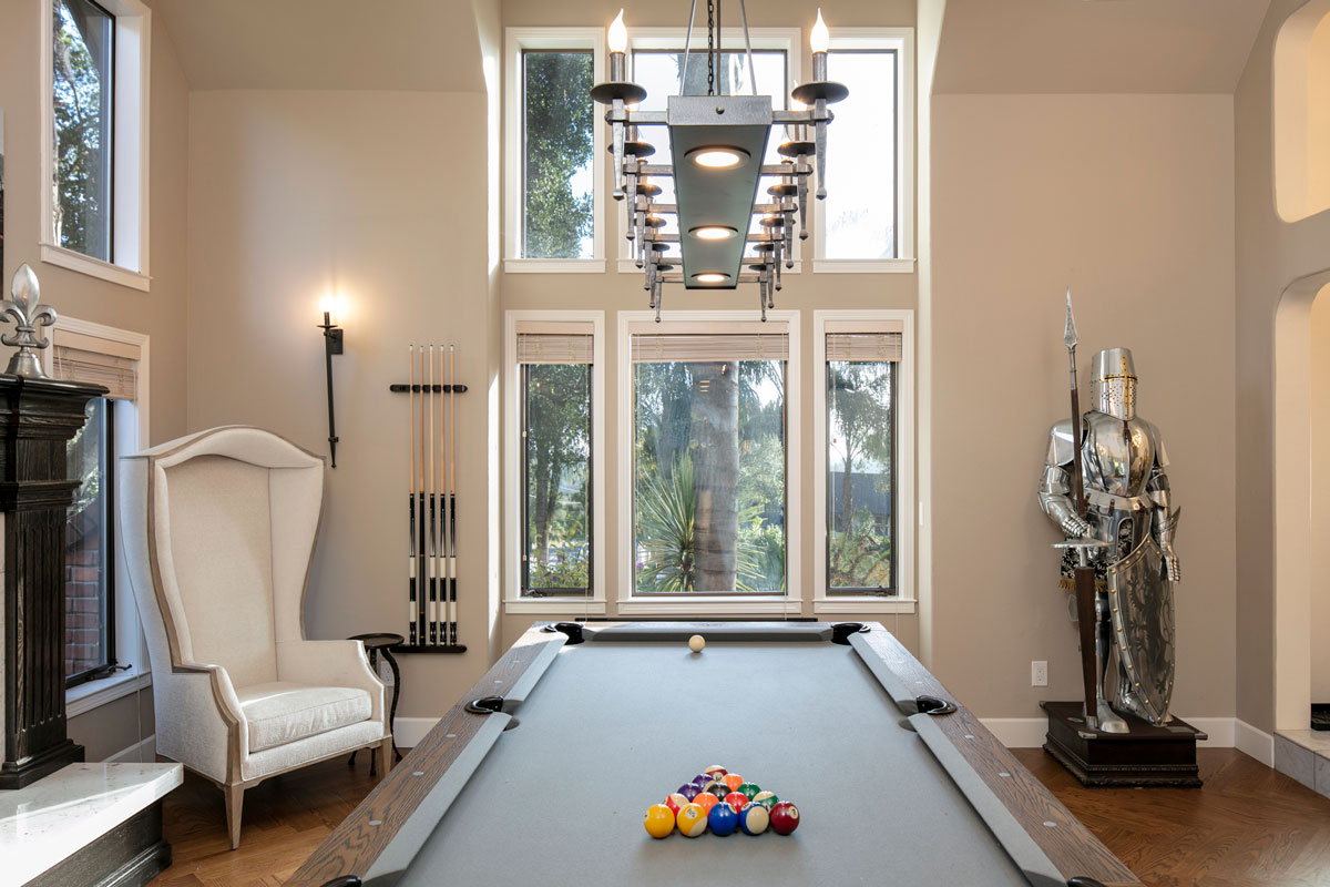 Pool table in front of large windows for natural light