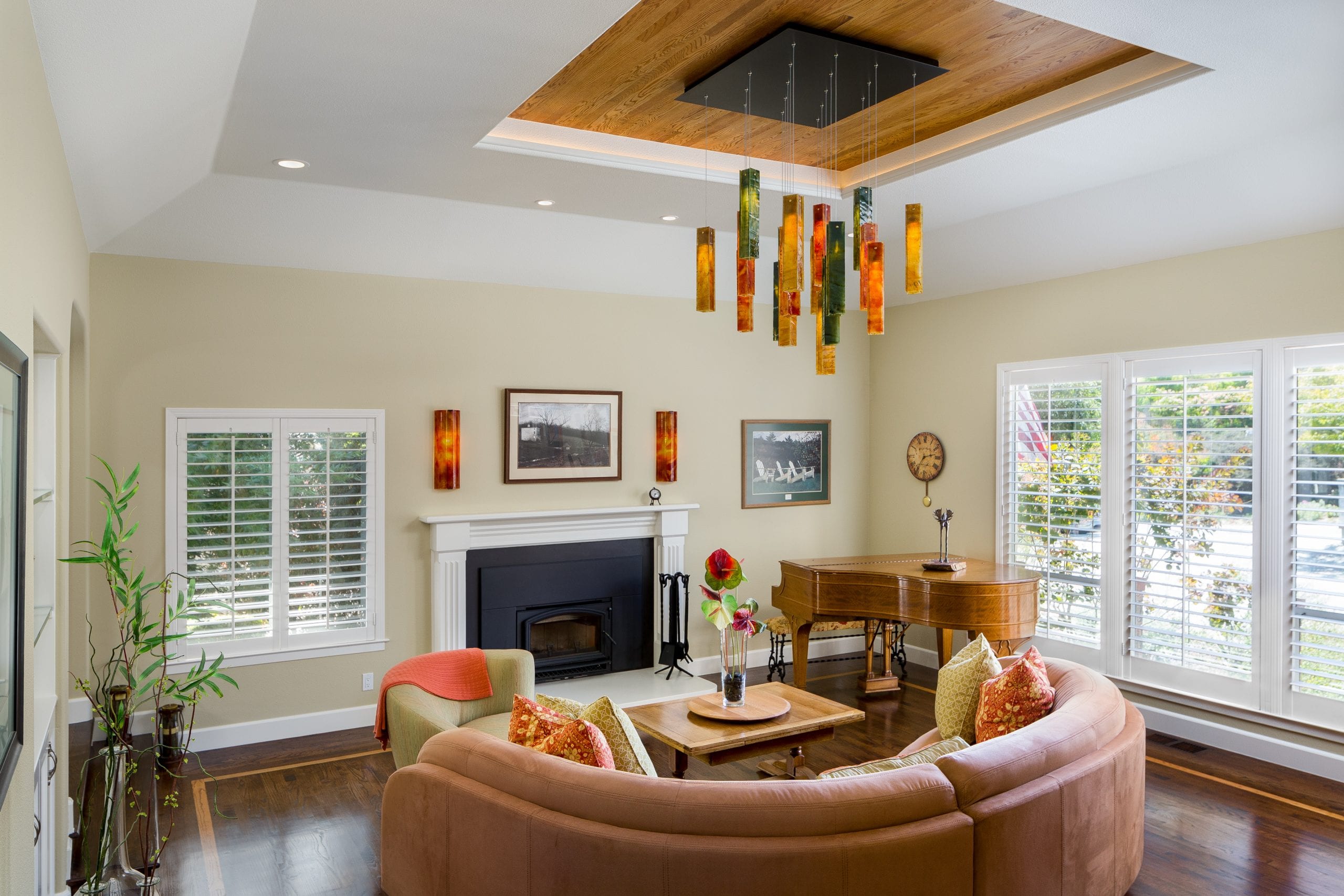 Spacious living room featuring embedded can lighting, natural light, and a luxurious fireplace with plenty of space to sit