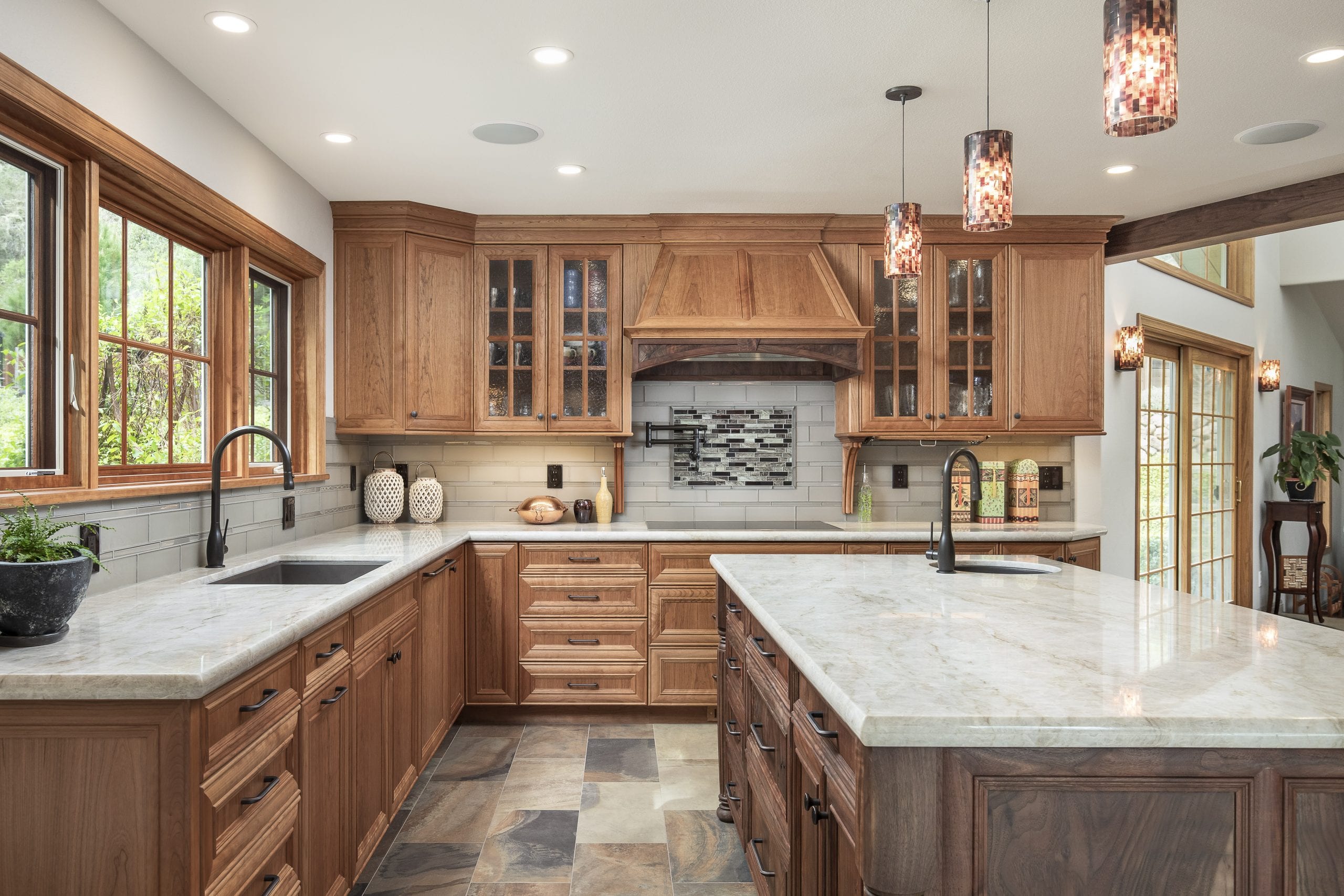 Newly remodeled kitchen with white marbled countertops and wooden cabinets