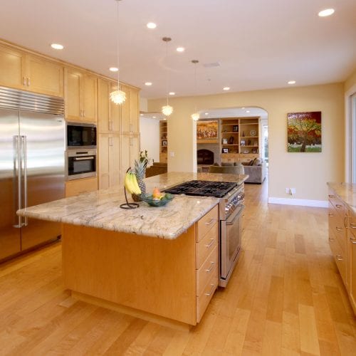 Kitchen island with fruit on top of the overhang