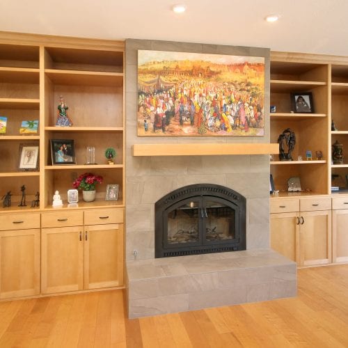 Shelving units bordering stone fireplace