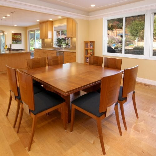 Rich wooden dining room table with seating for eight