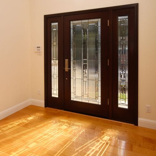 Black door with stenciled glass panels