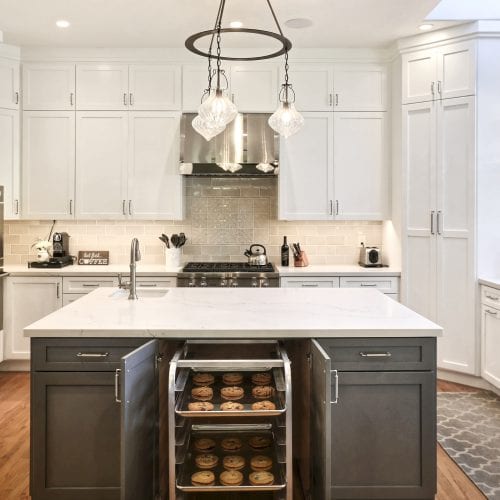 White marble counter on top of grey wooden island