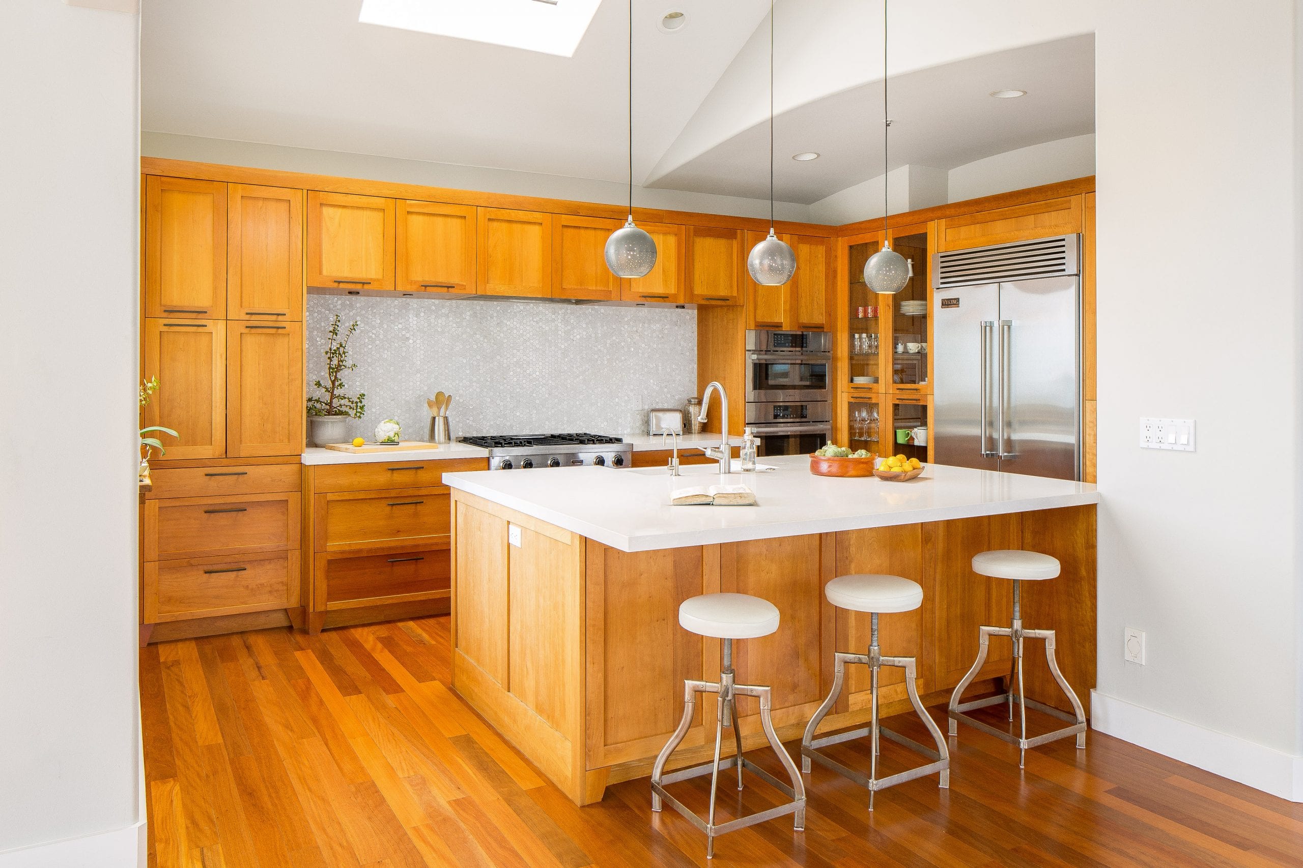 Kitchen remodel featuring matching hardwood cabinets and flooring