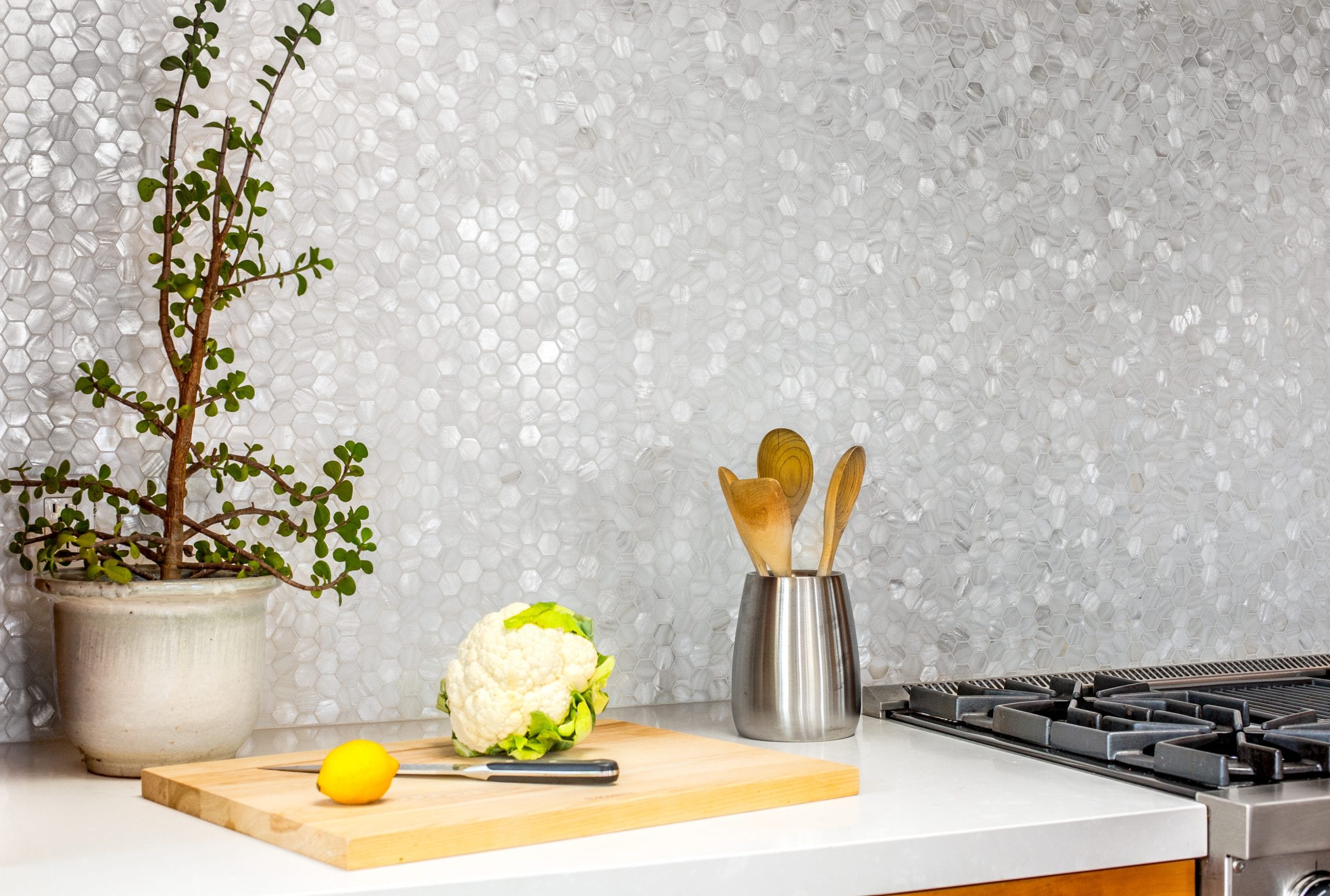 Hex-tile back splash over a kitchen countertop and stove