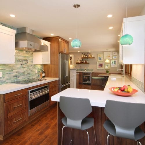 Contemporary bathroom remodel with wooden finishes and teal tile backsplash