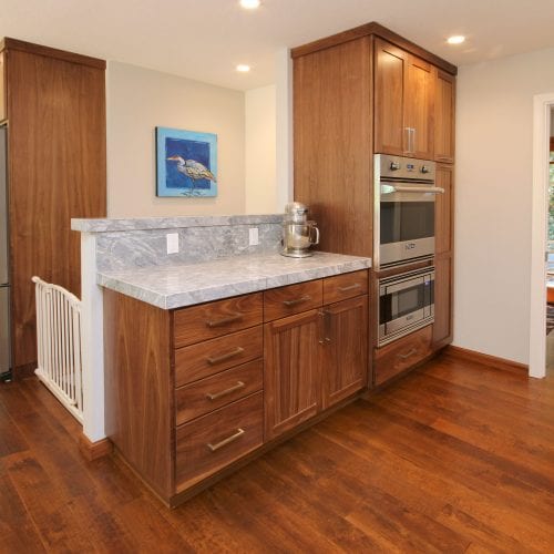 Wooden kitchen cabinets with a stainless steel double oven