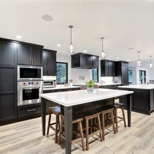 White marble counter kitchen island with light wood stools