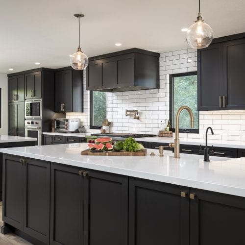 White tile backsplash with contrasting black fixtures