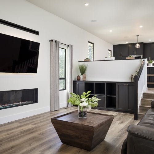 Living space with staircase up to connected kitchen