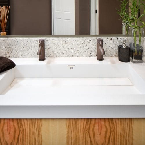 Square sink with two black faucets