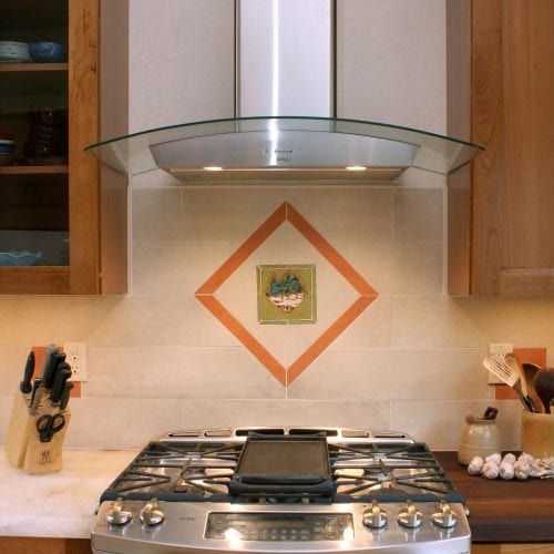 Stove backsplash with artistic tile in diamond frame