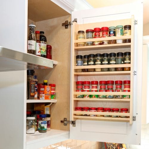 Kitchen cabinet with full spice rack and cooking essentials