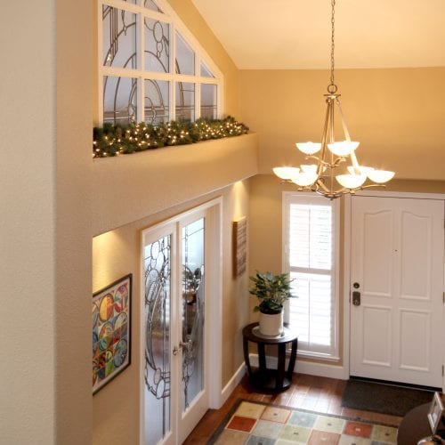 Home entryway with hanging chandelier