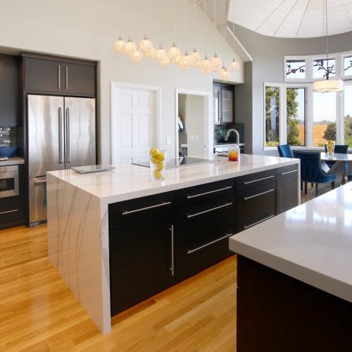 Black wood cabinets and drawers embedded into kitchen island