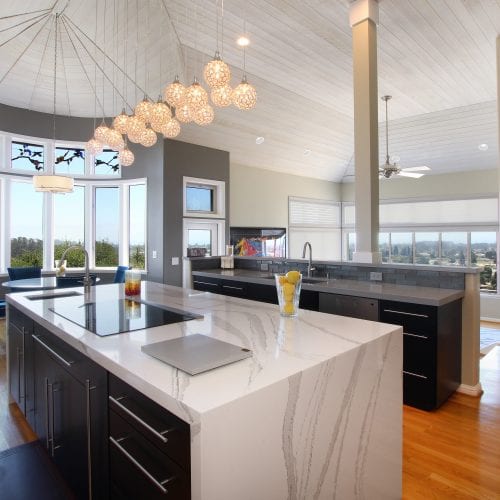 White marble counter wraps around black wood cabinetsAll-Dressed-Up-Kitchen-Remodel-in-Santa-Cruz2-500x500