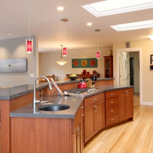 Granite grey countertop over red wood cabinets