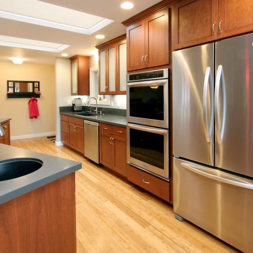 Kitchen with red wood cabinets and stainless steel appliances