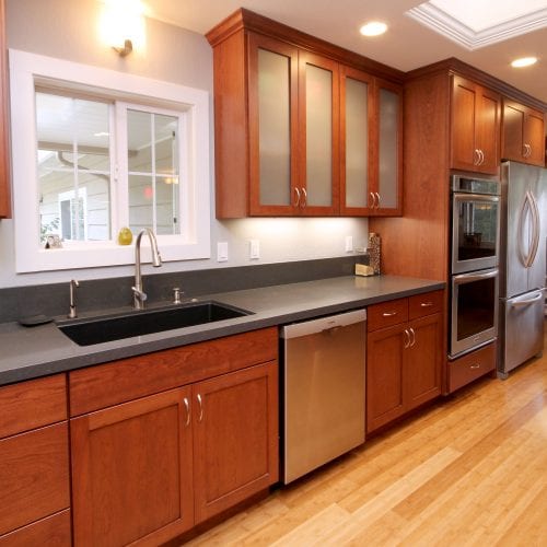 Red wood cabinets with glass paneling