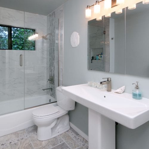 Bathroom with grey, neutral tones and a sliding glass shower door