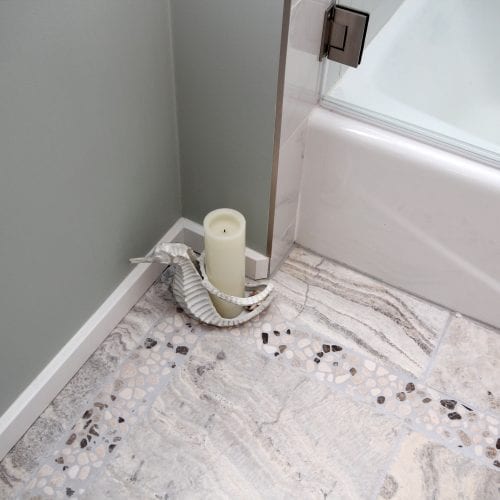 Bathroom flooring with spotted tile and candle holder decoration