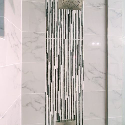 Shower tiling with a grey and white cascading effect