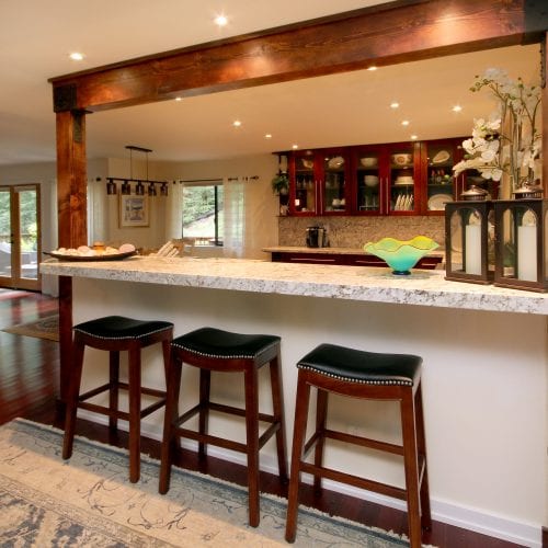 Kitchen remodel with bar style countertop and cozy lighting