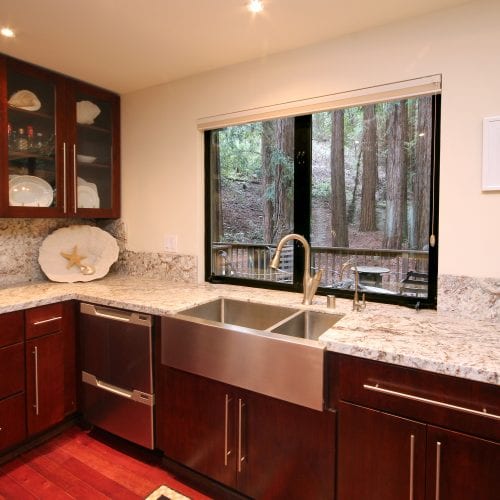 Kitchen counter with wall mounted cabinets and stainless steel sink