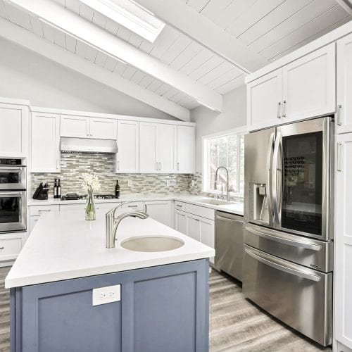 Close up of kitchen island with white marble countertops